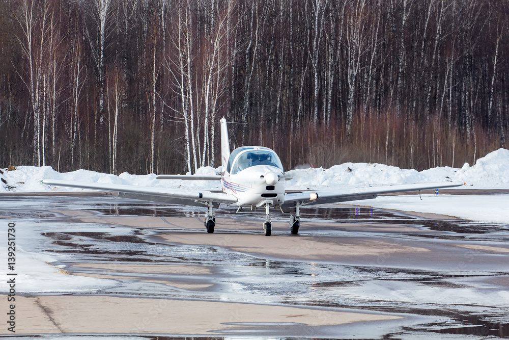 Small plane at the airport in winter Small plane at the airport in winter