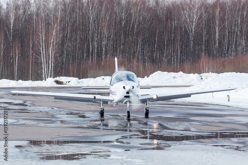 Small plane at the airport in winter