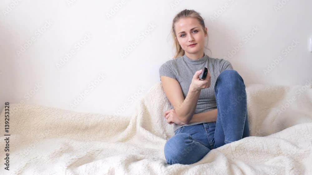 Smiling woman watching television Smiling woman watching television