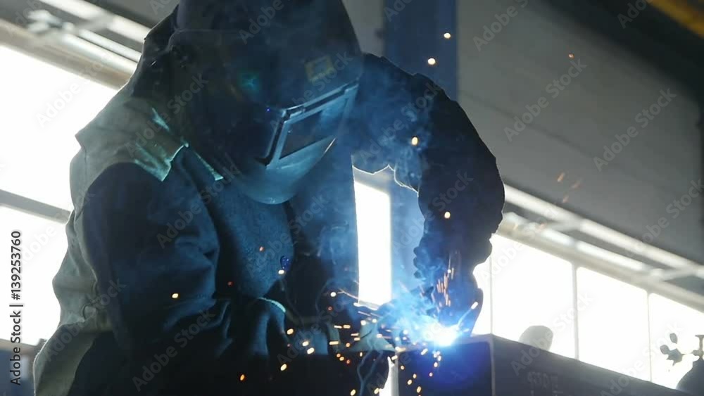 Welder Works Hard in Sparks Shower Clouseup