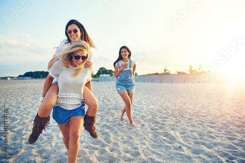Three girls spending time on beach together