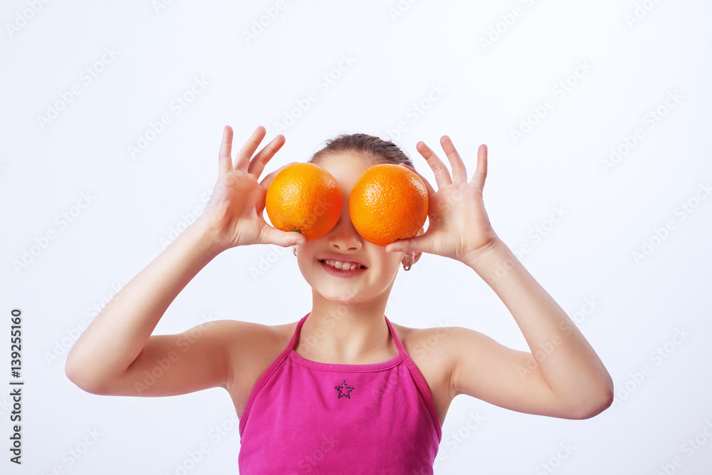The child with oranges. The concept of healthy eating and vegetarianism. The child with oranges. The concept of healthy eating and vegetarianism.