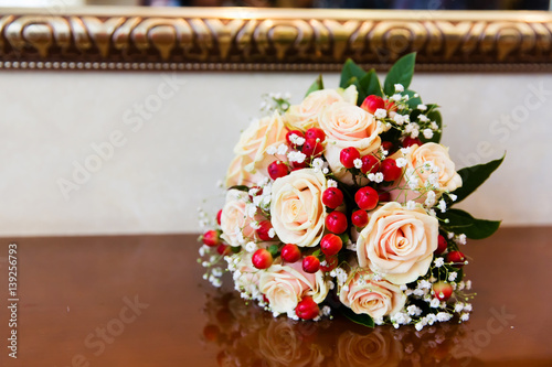 Beautiful wedding bouquet with pink roses and red berries photo