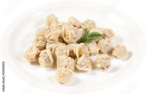 Dumplings and parsley - russian pelmeni - italian ravioli - on white plate isolated