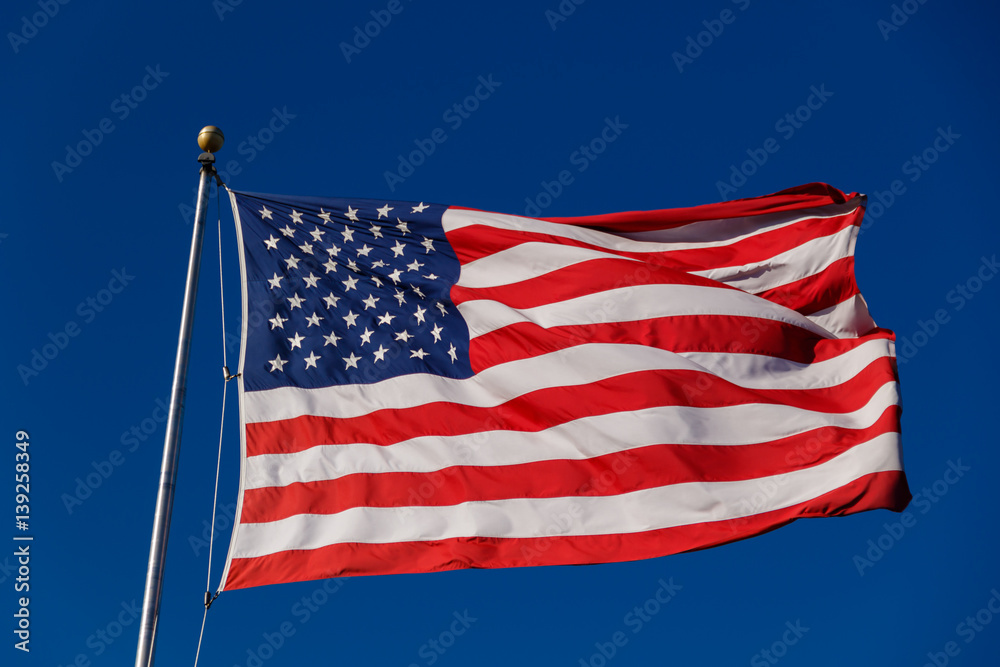 Fototapeta premium American Flag against blue sky