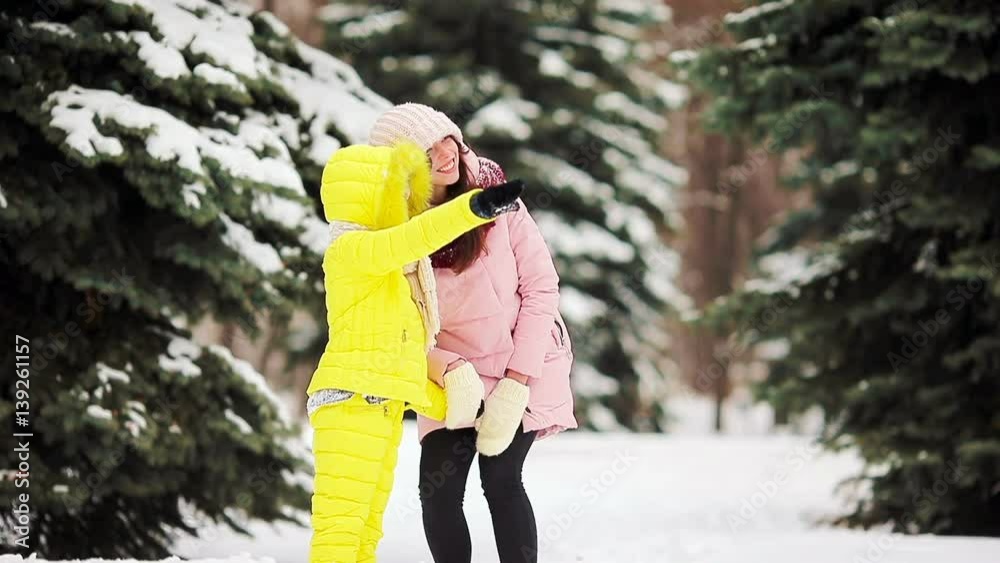 Family at snow weather outdoors on beautiful winter day