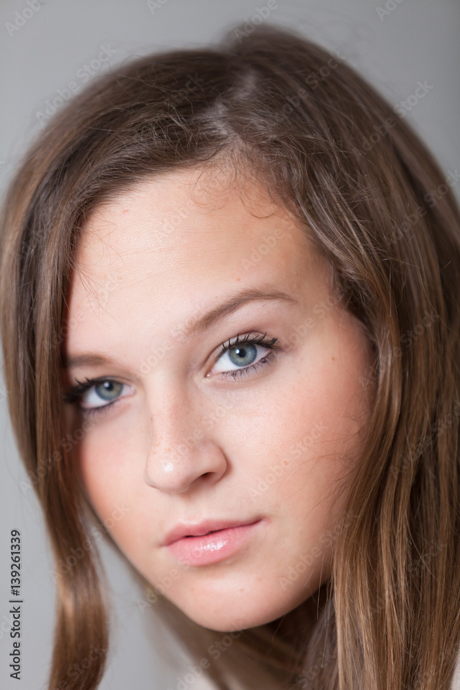 Close up of glamorous and cute girl with blue eyes