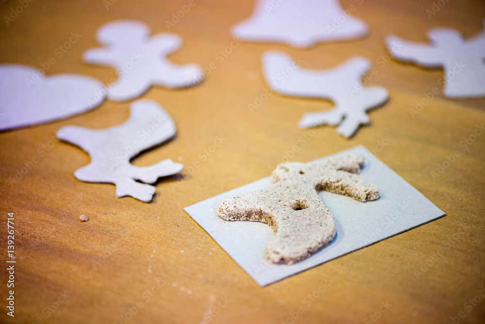 Christmas baking background with salt dough, cookie templates. Baking gingerbread cookies. Kids having fun, making reindeers, stars, angels, hearts from dough. Decorations for christmas tree. Christmas baking background with salt dough, cookie templates. Baking gingerbread cookies. Kids having fun, making reindeers, stars, angels, hearts from dough. Decorations for christmas tree.