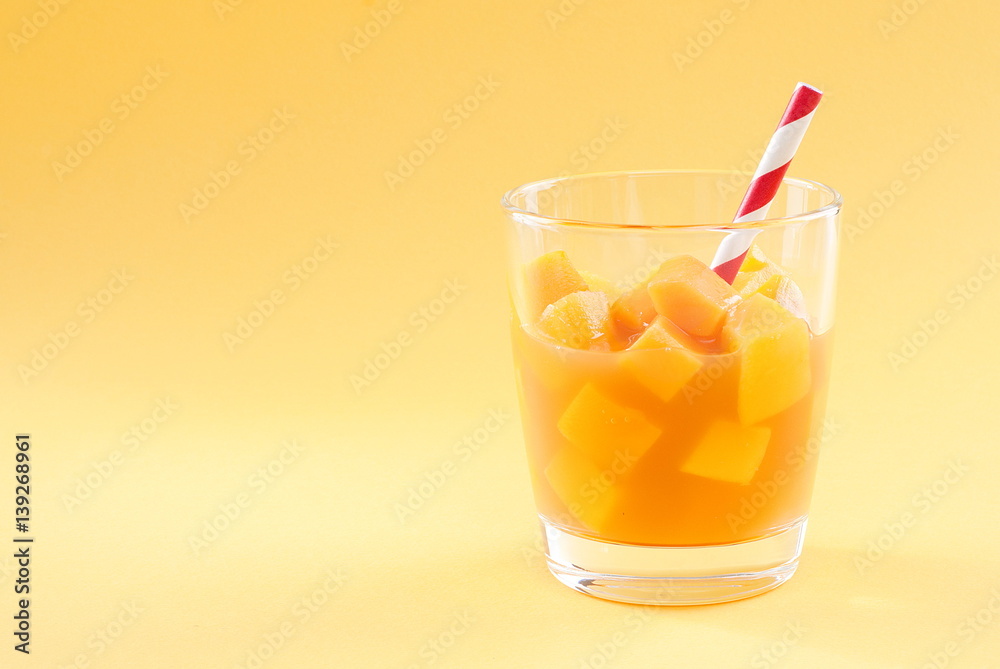 cubes of mango pulp isolated on a yellow background