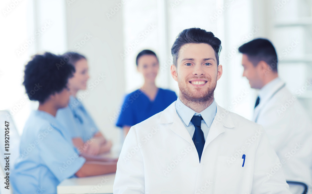 happy doctor over group of medics at hospital