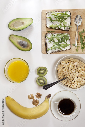 The ideal breakfast for the proper energy for the full day. Coffee with milk, orange juice, fruit . photo