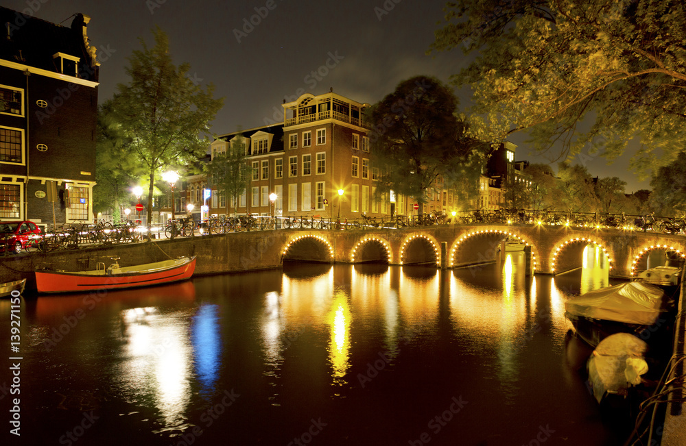 Lights on canal bridges at night Amsterdam, Netherlands