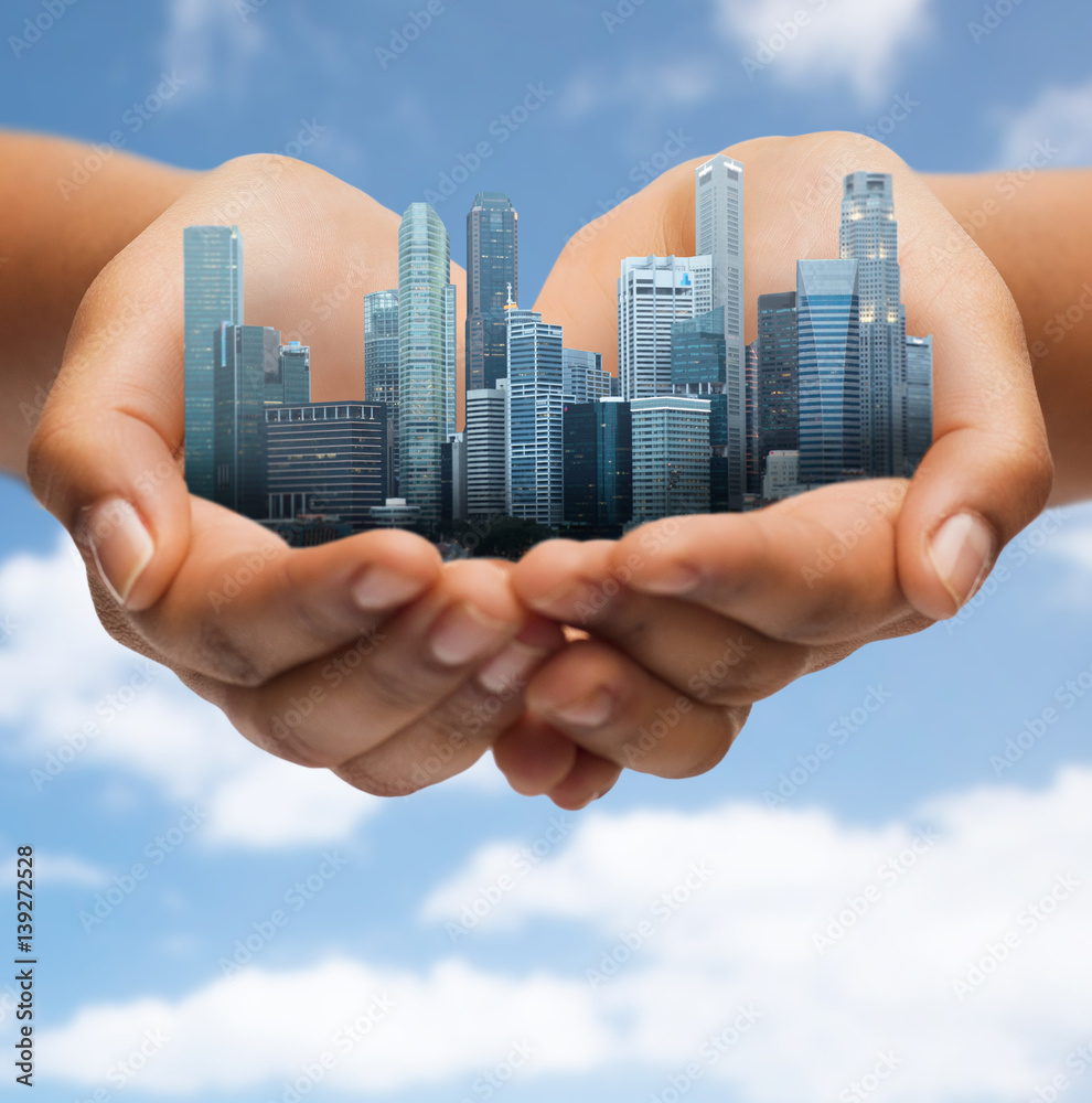 hands holding city over blue sky background Stock Photo Adobe Stock