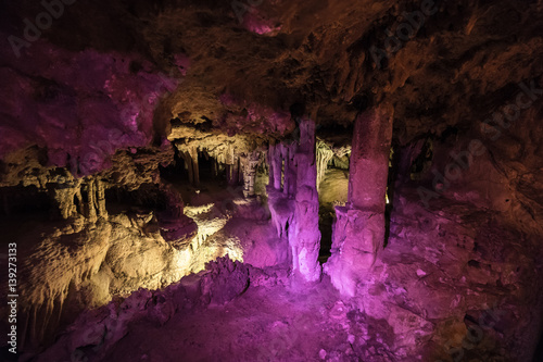 underground cave illuminated by colorful light