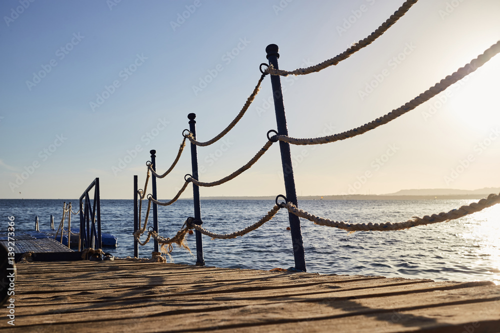 Naklejka premium pontoon with rope barriers in the sea