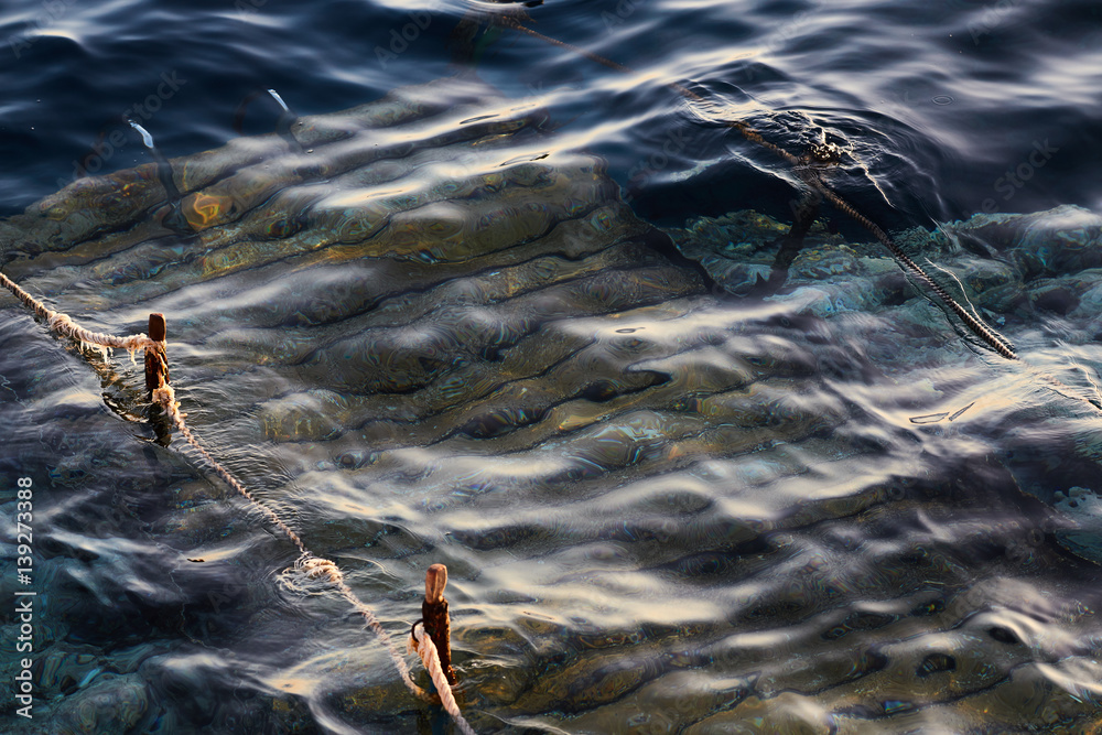 Fototapeta premium underwater pontoon with rope barriers in the sea