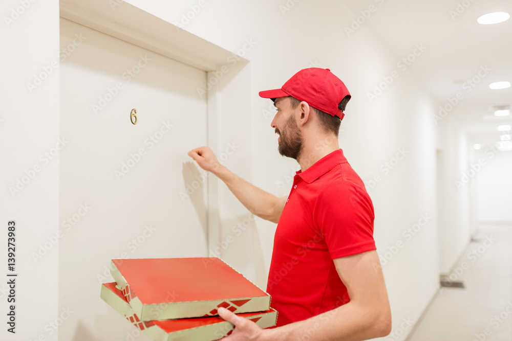 delivery man with pizza boxes knocking on door delivery man with pizza boxes knocking on door