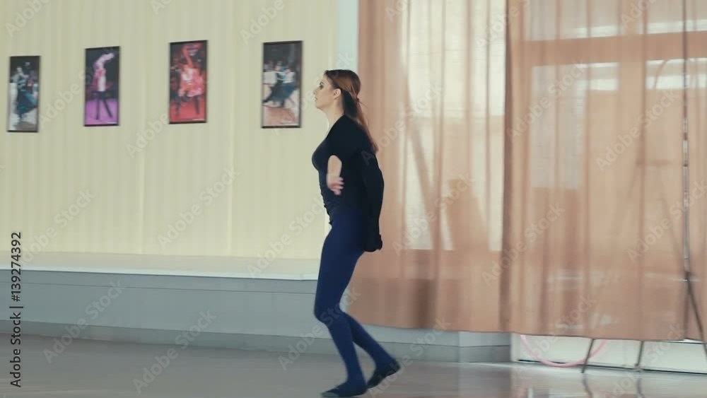 Graceful girl training ballet poses in dance studio. Slowly Graceful girl training ballet poses in dance studio. Slowly