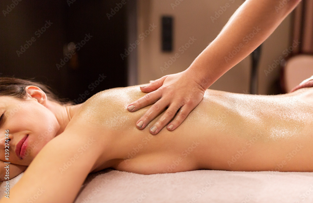 Fototapeta premium woman lying and having back massage at spa