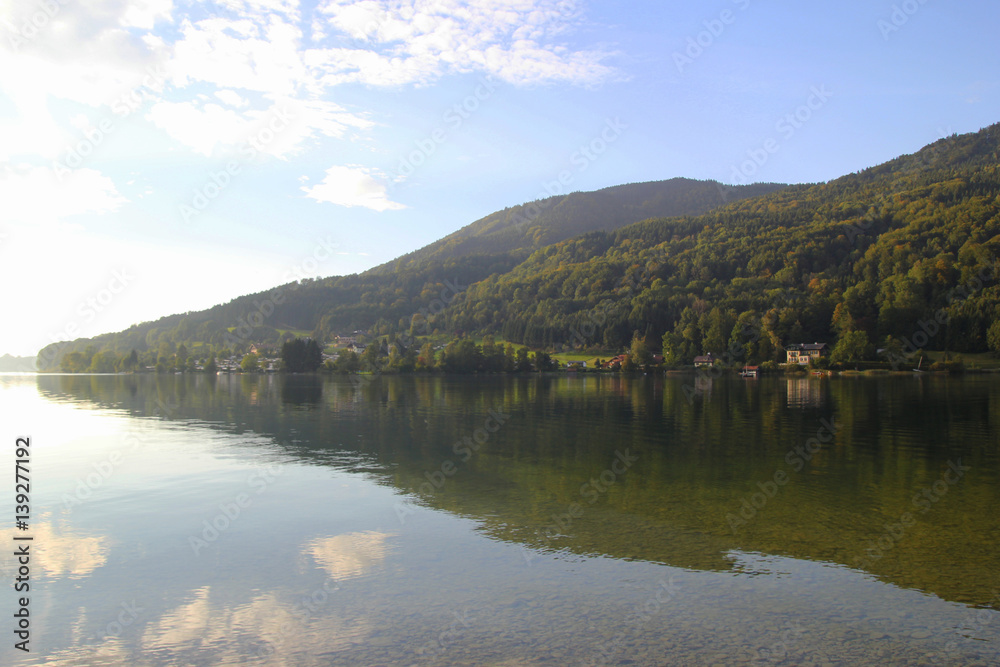 Travel to Attersee, Austria. The view on the lake with the mountains on the background in the sunny day.