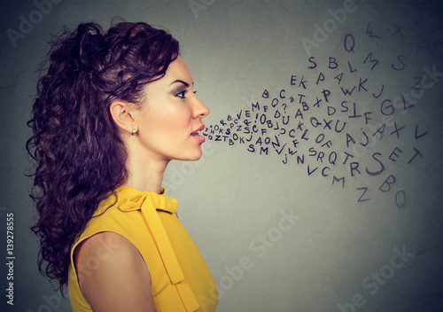 Woman talking with alphabet letters coming out of her mouth