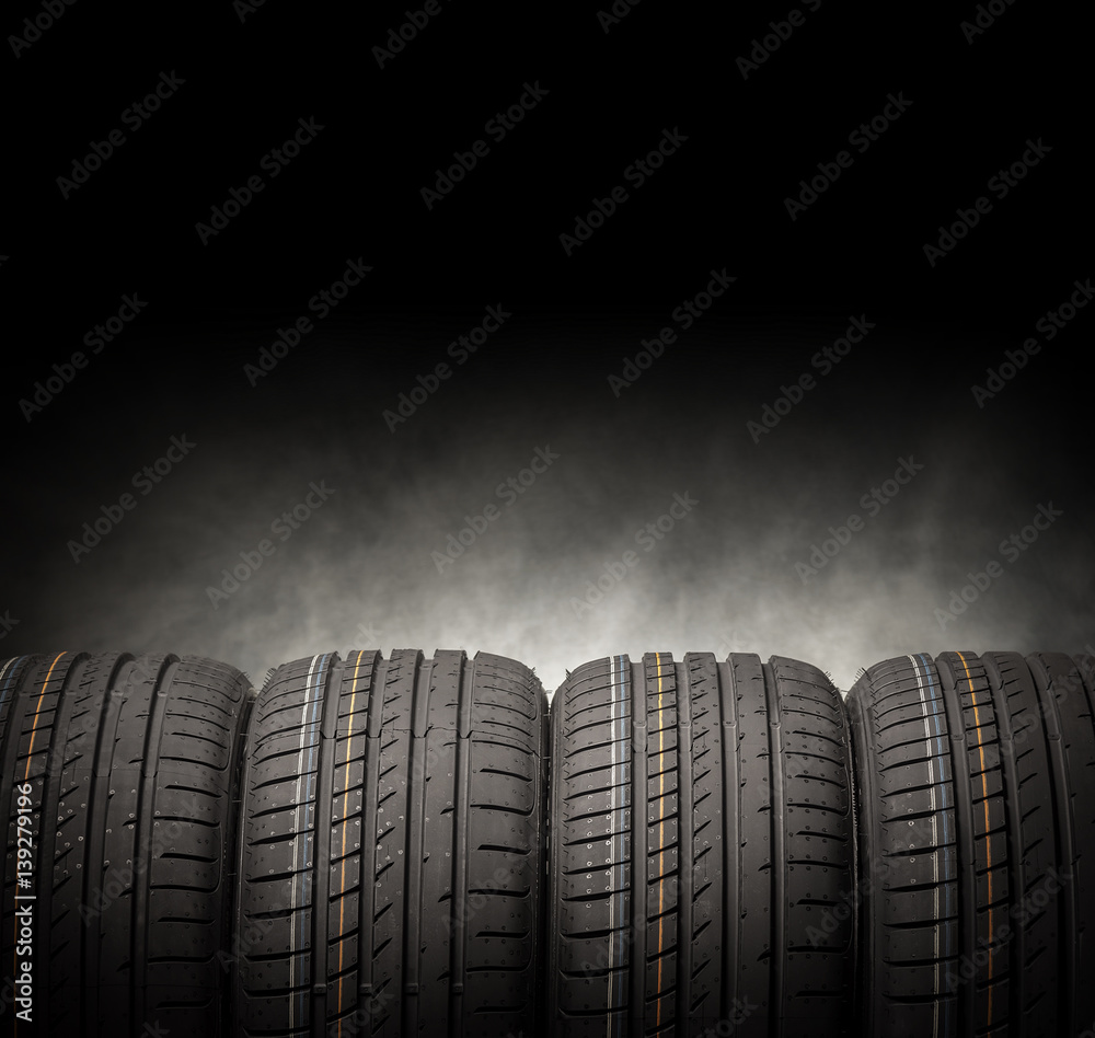 Car tires on a dark background.