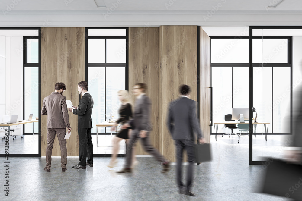 People walk in a lobby of office People walk in a lobby of office