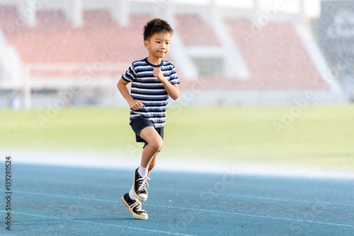 Boy running on the blue track