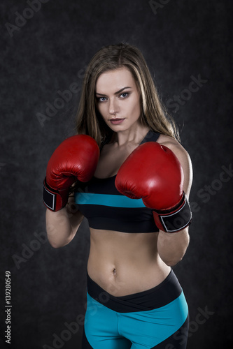 Strict boxing woman in red box gloves