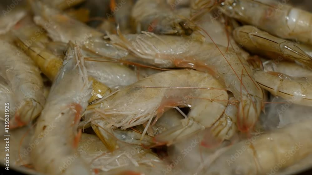 Raw fresh shrimp frying and smoking in pan. Raw fresh shrimp frying and smoking in pan.