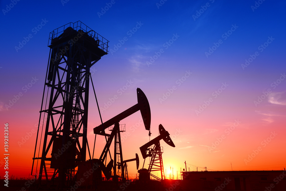 Pumping unit is working in oil field of the sunset Pumping unit is working in oil field of the sunset