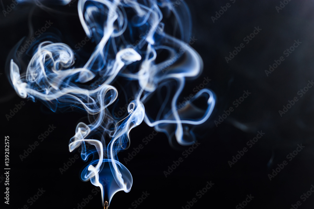 Incense smoke lit and shot in studio Incense smoke lit and shot in studio