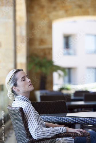 Woman dozing in armchair photo