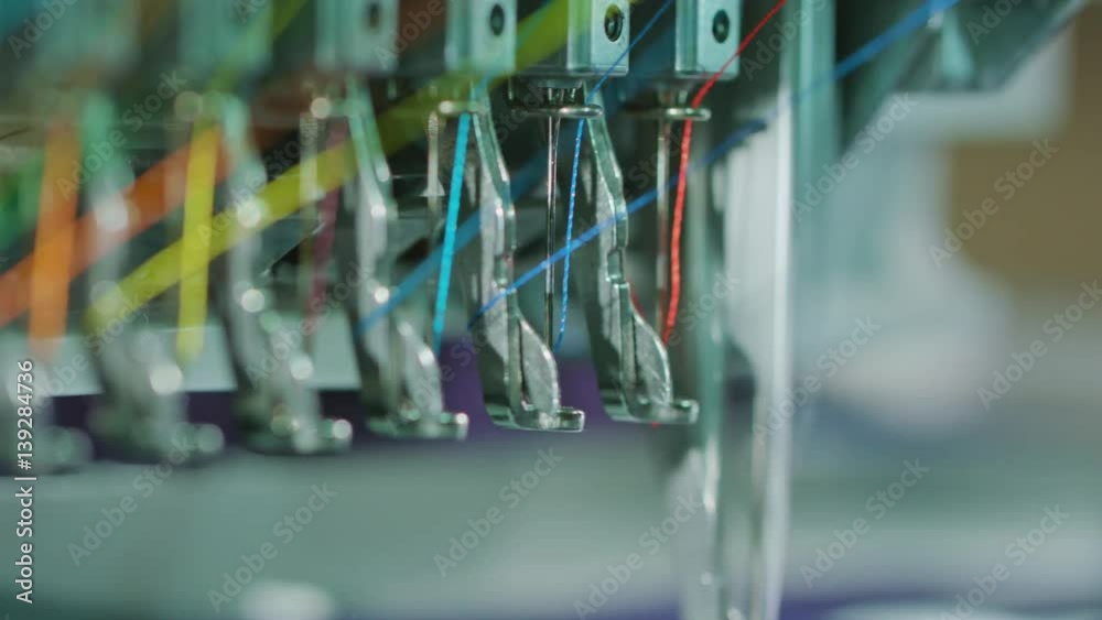 Embroidery machine starting to embroider with a needle on the fabric