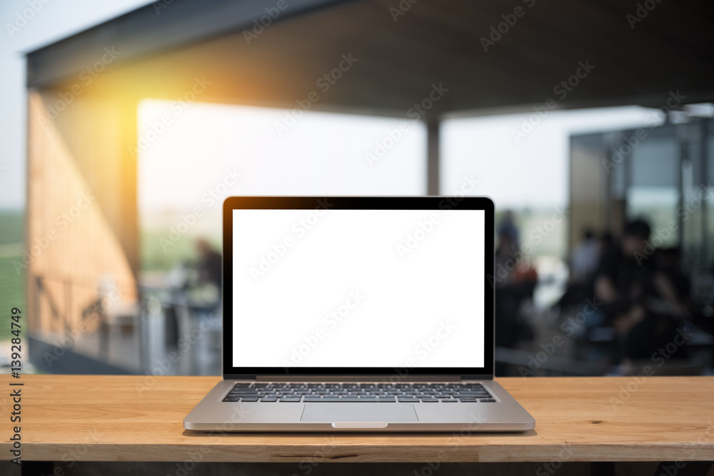 Laptop with blank screen on table of a cafe. Laptop with blank screen on table of a cafe.