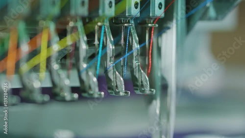Embroidery machine starting to embroider with a needle on the fabric
