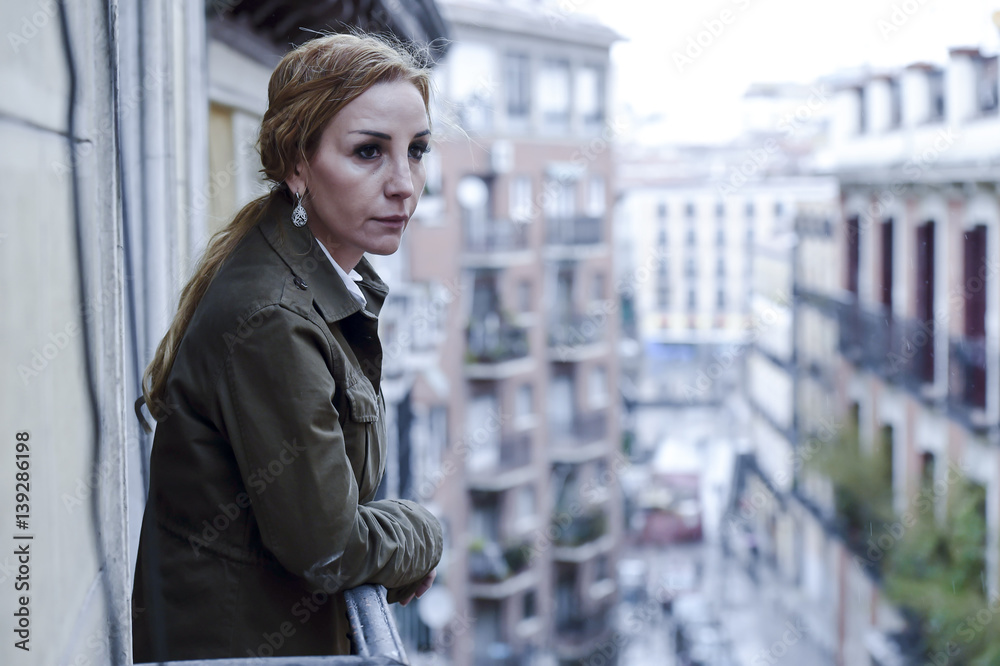 lost and sad woman at home balcony suffering depression looking thoughtful and solitary lost and sad woman at home balcony suffering depression looking thoughtful and solitary