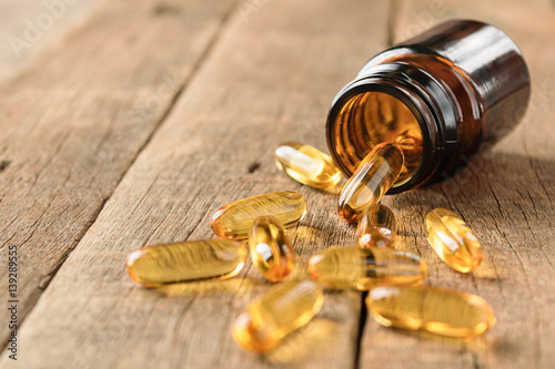 closeup supplements vitamins bottle on wood background photo