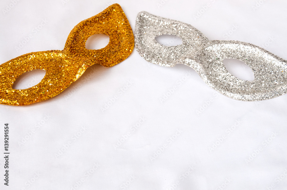 Gold and silver theatrical masks on a light background Gold and silver theatrical masks on a light background