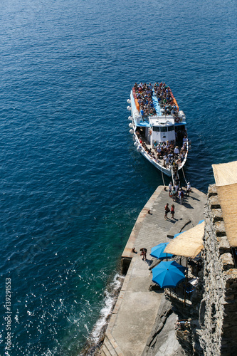 Tourists disembarking from a tour boat along the Cinque Terre, Italy.