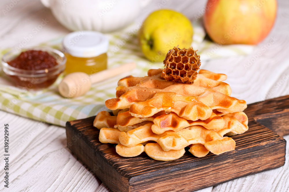 Honey pouring on a fresh waffles. Breakfast with Belgian waffles Honey pouring on a fresh waffles. Breakfast with Belgian waffles