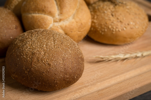Tasty fresh buns on the wooden background