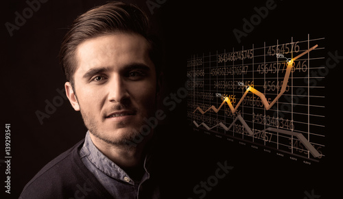 Happy businessman with a growing graph