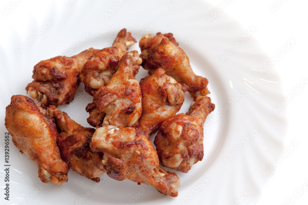 Fried chicken wings ready to serve on the plate white background