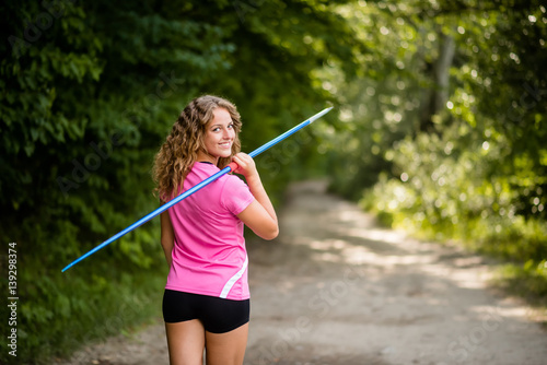 Athletic young woman carrying a javelin © Martinan