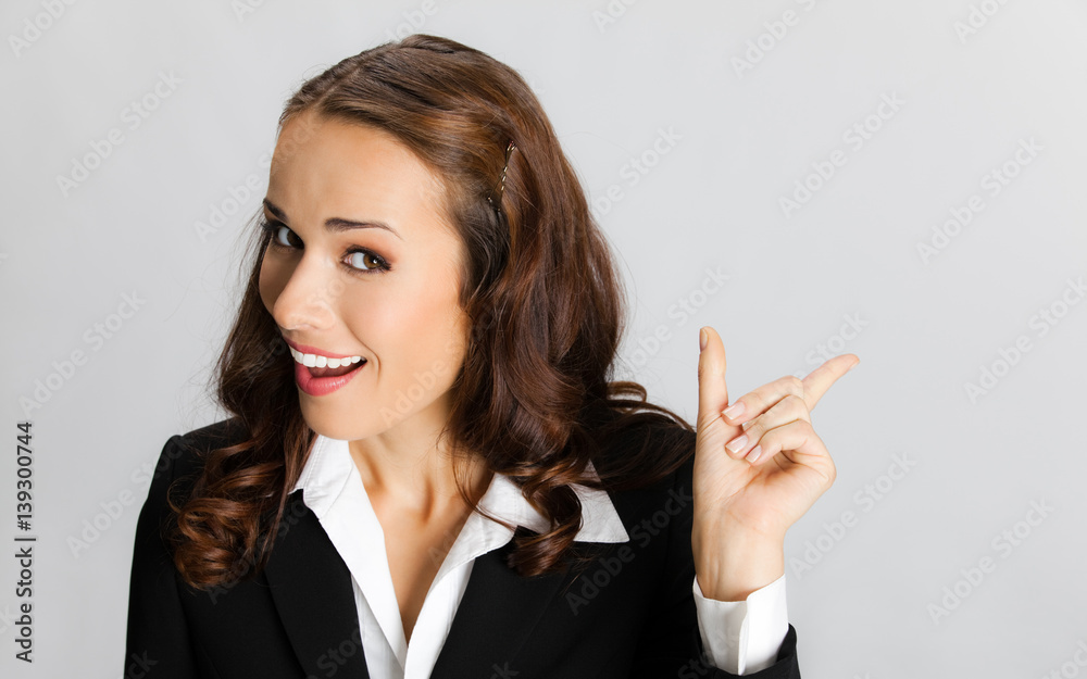 Business woman showing blank area for sign or copyspase, over gr Business woman showing blank area for sign or copyspase, over gr