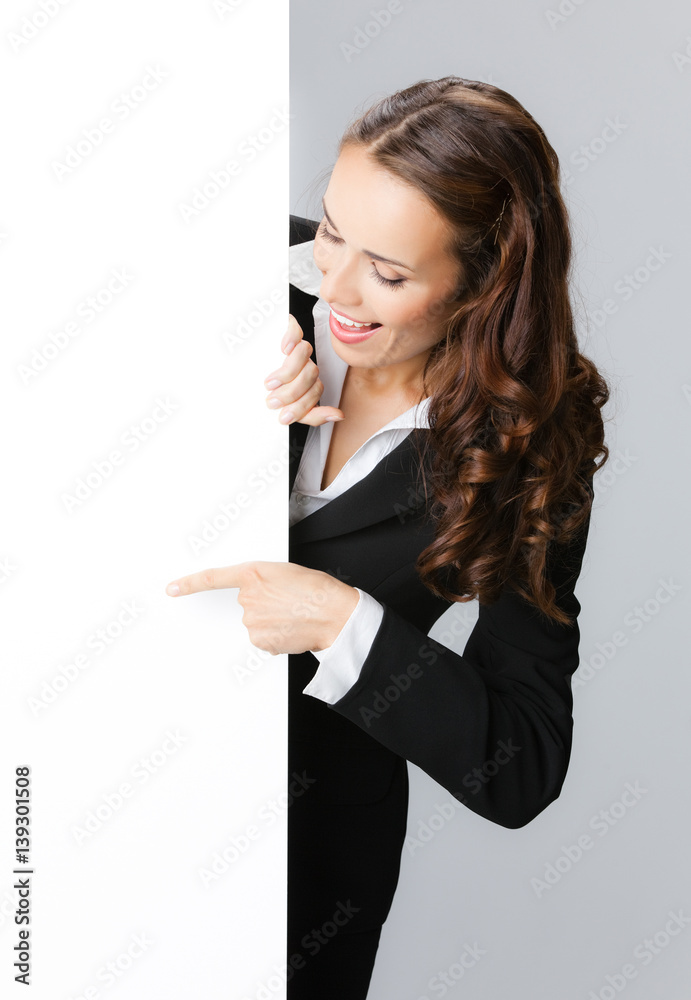 Businesswoman showing signboard, over grey Businesswoman showing signboard, over grey
