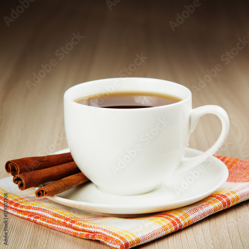 Hot cup of warming tea with cinnamon