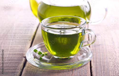 Green herb tea in glass cup
