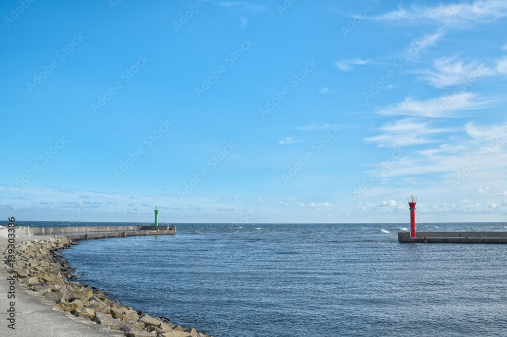 Port entrance on Baltic sea. Summer landscape with clear blue sky.